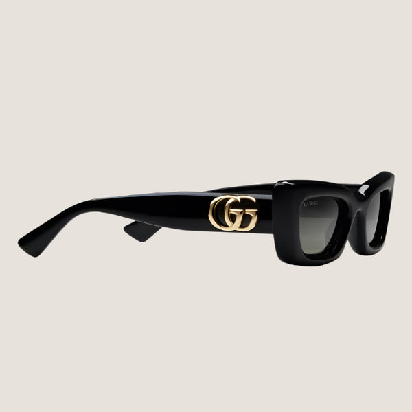 GUCCI sunglasses with iconic GG branding and stylish black frames.